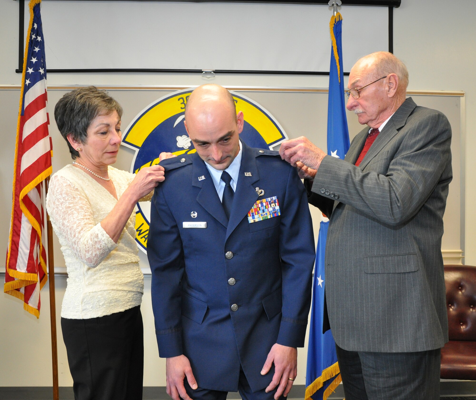 Newly promoted Lt. Col. John Anderson was pinned by his mother and father, Kathleen and John Anderson, during a ceremony that took place just prior to the assumption of command in which the lieutenant colonel assumed command of the 302nd Civil Engineer Squadron. (U.S. Air Force photo/Tech. Sgt. Peter Dean)
