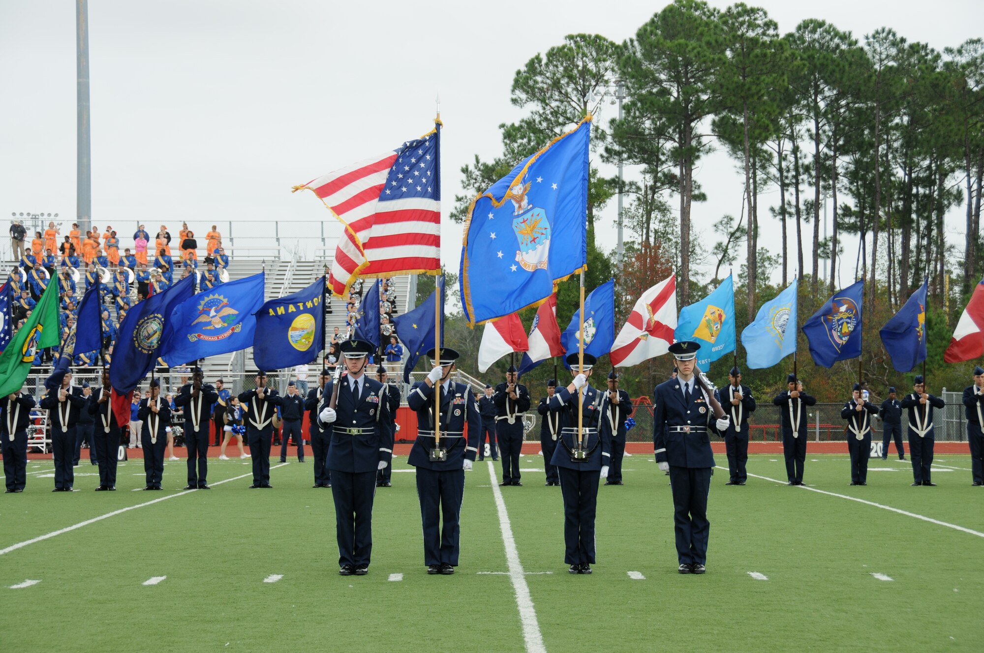 The Keesler Honor Guard and flag bearers carrying the 50 state flags participated in the Mississippi State Bowl game between Mississippi Gulf Coast Community College and Blinn College held at Biloxi High School Stadium Dec. 4, 2011.  Brig. Gen. Andrew Mueller, 81st Training Wing commander, was honored by MGCCC with the Spirit of MGCCC Award for his support of the college's athletic and academic programs.  MGCCC defeated Blinn College 46-17.  (U.S. Air Force photo by Kemberly Groue)