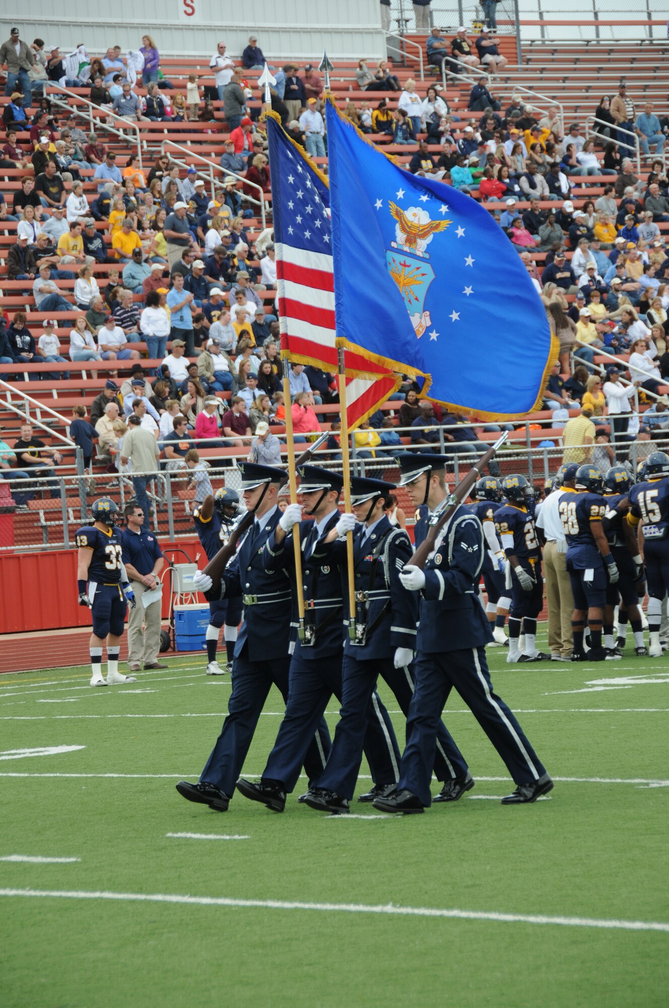 The Keesler Honor Guard and flag bearers carrying the 50 state flags participated in the Mississippi State Bowl game between Mississippi Gulf Coast Community College and Blinn College held at Biloxi High School Stadium Dec. 4, 2011.  Brig. Gen. Andrew Mueller, 81st Training Wing commander, was honored by MGCCC with the Spirit of MGCCC Award for his support of the college's athletic and academic programs.  MGCCC defeated Blinn College 46-17.  (U.S. Air Force photo by Kemberly Groue)