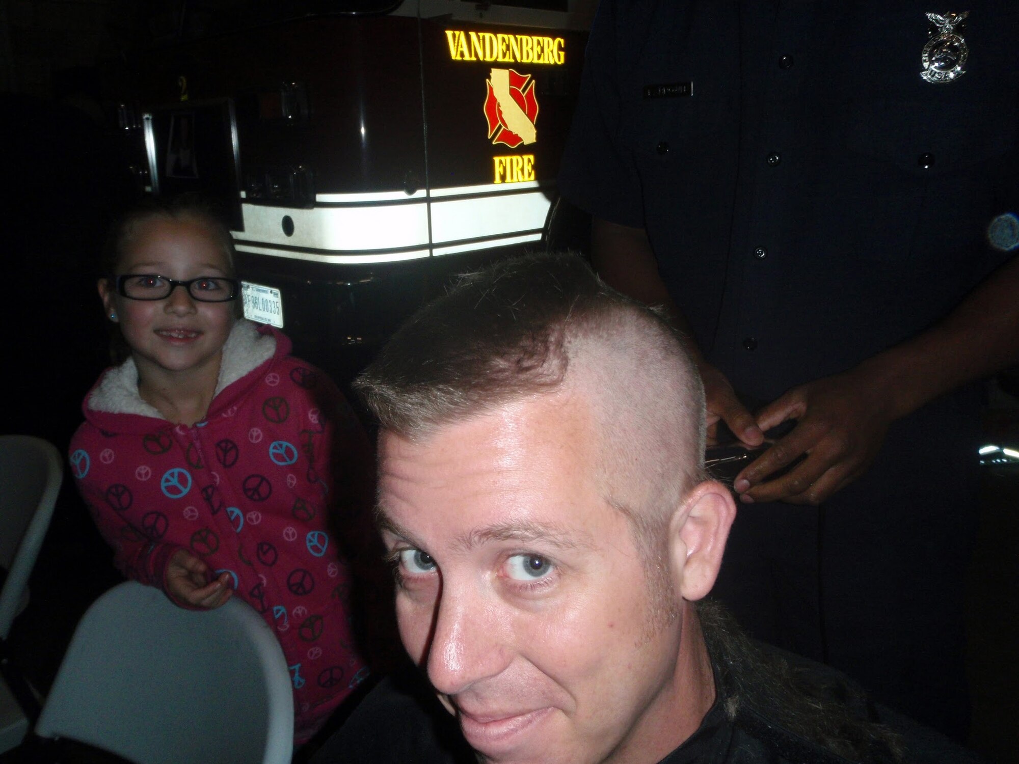 VANDENBERG AIR FORCE BASE, Calif.—Robert Raffel, a Vandenberg Fire Department firefighter gets his head shaved in honor of his nephew, Ryan, here Sunday, Nov. 20, 2011.  Ryan was diagnosed with leukemia earlier this year and is currently being treated at Walter Reed National Medical Center, District of Columbia. (Courtesy photo) 
