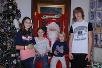 (From Left) Garrett, Madison, Kelsie and Brody Collins pose with Santa Claus during the Joint Base San Antonio-Randolph Tree Lighting Ceremony Dec. 1 in the Taj Mahal . (U.S. Air Force photo/Rich McFadden) (released)
