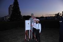 Col. Robert Brigford (left), 502nd Air Base Wing deputy commander, helps Zachary Wagner and Alicia Lundy,Randolph Elementary School students, throw the switch to light the Joint Base San Antonio-Randolph Christmes tree at the JBSA-Randolph Tree Lighting Ceremony Dec. 1 in Washington Circle.  (U.S. Air Force photo/Rich McFadden) (released)