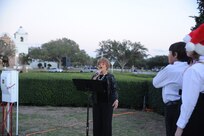 Dolores Walter, Randolph Idol runner-up, sings the national anthem to kick off the Joint Base San Antonio-Randolph Tree Lighting Ceremony Dec. 1 in Washington Circle. (U.S. Air Force photo/Rich McFadden) (released)