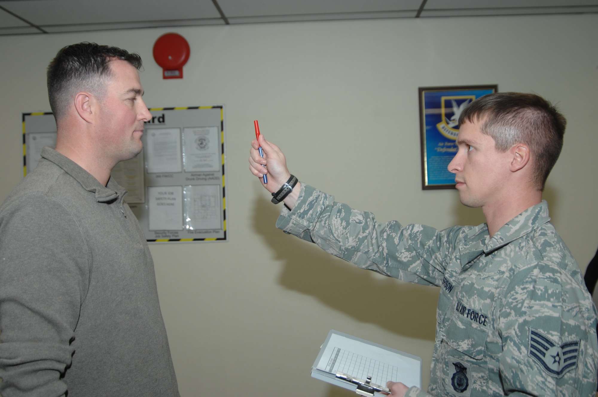 Staff Sgt. Gabriel Masterson, 366th Security Forces patrolman, assesses the ocular efficiency of Master Sgt. Shane Ward, 366th Operations Support Squadron unit deployment manager, Dec. 2, 2011, at Mountain Home Air Force Base, Idaho, as part of training for the standardized field sobriety testing. Ward and four other volunteers assisted the 366th SFS with the training which teaches patrolmen specific skills to determine if an individual is under the influence of alcohol. (U.S. Air Force photo by photo by Senior Airman Benjamin Sutton)