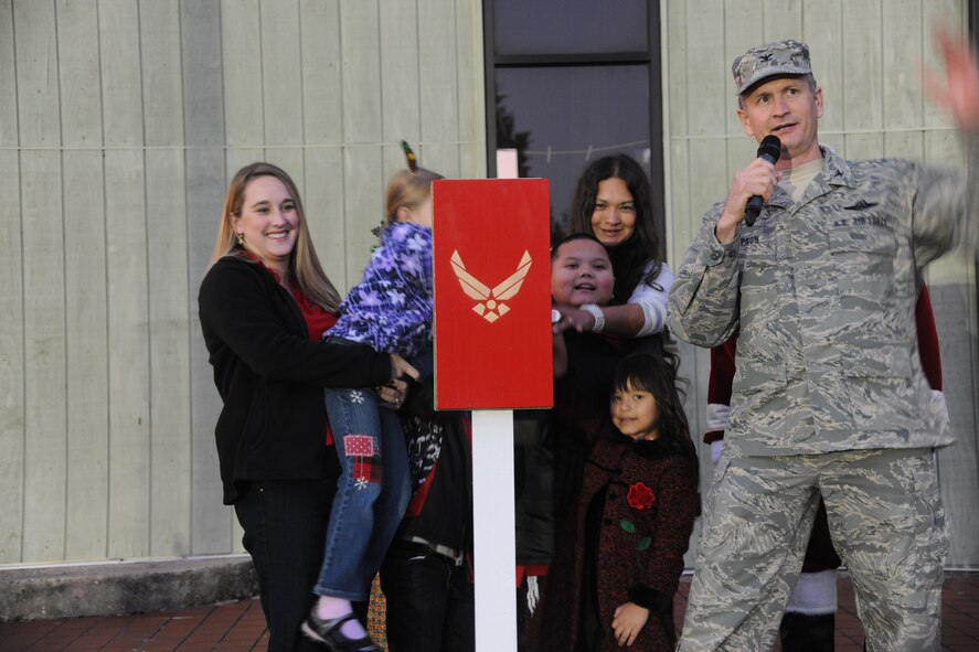 Two families of deployed Airmen stand alongside U.S. Air Force Col. Billy Thompson, 23rd Wing commander, as they prepare to light the Christmas tree during the Annual Base Tree Lighting and Holiday Parade at Moody Air Force Base, Ga., Dec. 2, 2011. Family, friends and coworkers gathered to watch the tree lighting which honored the deployed Airmen who are away during the holidays. (U.S. Air Force photo by Airman 1st Class Paul Francis/Released)
