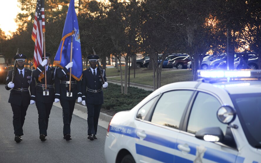 The Moody Air Force Base Honor Guard presents the colors during the Annual Base Tree Lighting and Holiday Parade Dec. 2, 2011. The parade also featured appearances by the 23rd Civil Engineer Squadron fire department, Green Knight members, the Grinch, Santa Claus and more. (U.S. Air Force photo by Airman 1st Class Paul Francis/Released)