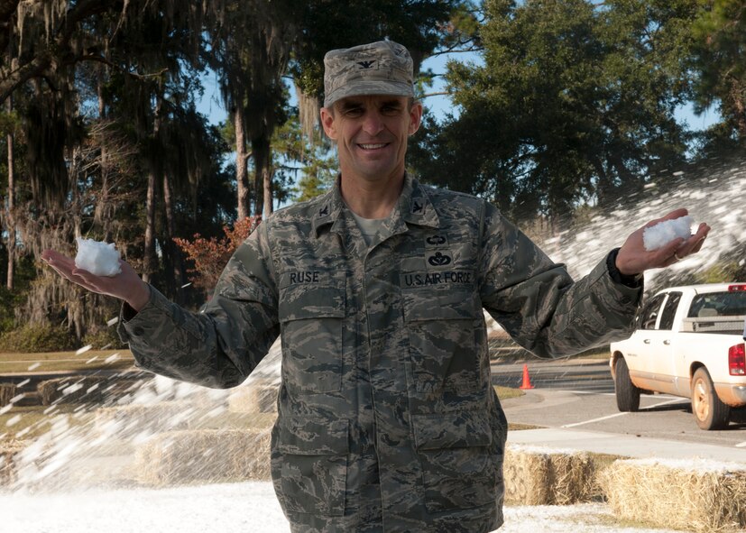 U.S. Air Force Col. Mark Ruse, 23rd Mission Support Group commander, holds up “snow” made from a snow gun for the annual base tree lighting ceremony at the President George W. Bush Air Park at Moody Field, Moody Air Force Base, Ga., Dec. 2, 2011. Two pits bordered with hay stacks to sit on were filled with two feet of snow made from 80,000 pounds of ice blocks to create a winter atmosphere for attendants at the event. (U.S. Air Force photo by Senior Airman Eileen Meier/Released)