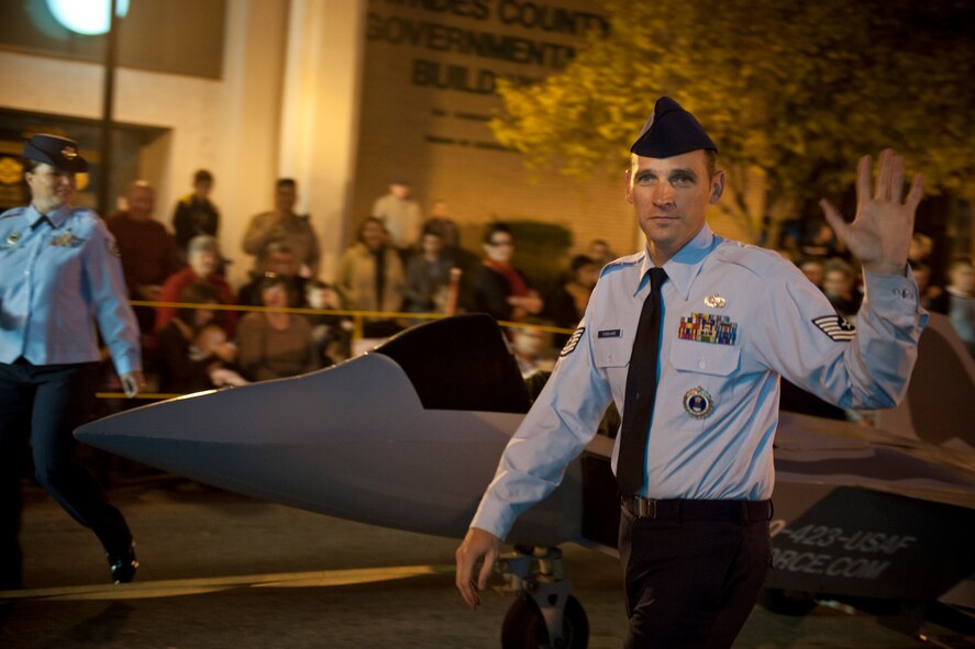 U.S. Air Force Tech. Sgt. Garrett Forehand, 336th Recruiting Squadron enlisted accession recruiter, waves to a crowd during the Greater Valdosta Community Christmas Parade in Valdosta, Ga., Dec. 3, 2011. The 336th RCS is a tenant unit on Moody Air Force Base, Ga., and covers areas in Georgia, South Carolina, Florida and Alabama. (U.S. Air Force photo by Staff Sgt. Jamal D. Sutter/Released) 