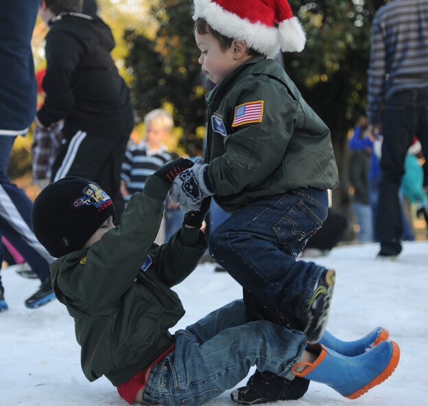 Moody Community children play in the snow during the Annual Base Tree Lighting and Holiday Parade at Moody Air Force Base, Ga., Dec. 2, 2011. Snow was provided by snow makers to give  the children a winter feel in south Georgia.(U.S. Air Force photo by Airman 1st Class Paul Francis/Released)
