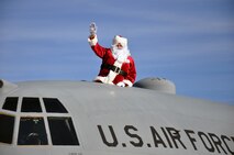 Santa Claus (Lt. Col. Jerry Lobb) waves to members of the 908th Airlift Wing family upon his arrival aboard a C-130 at Maxwell Air Force Base Dec. 4. (Air Force photo/Gene Hughes)