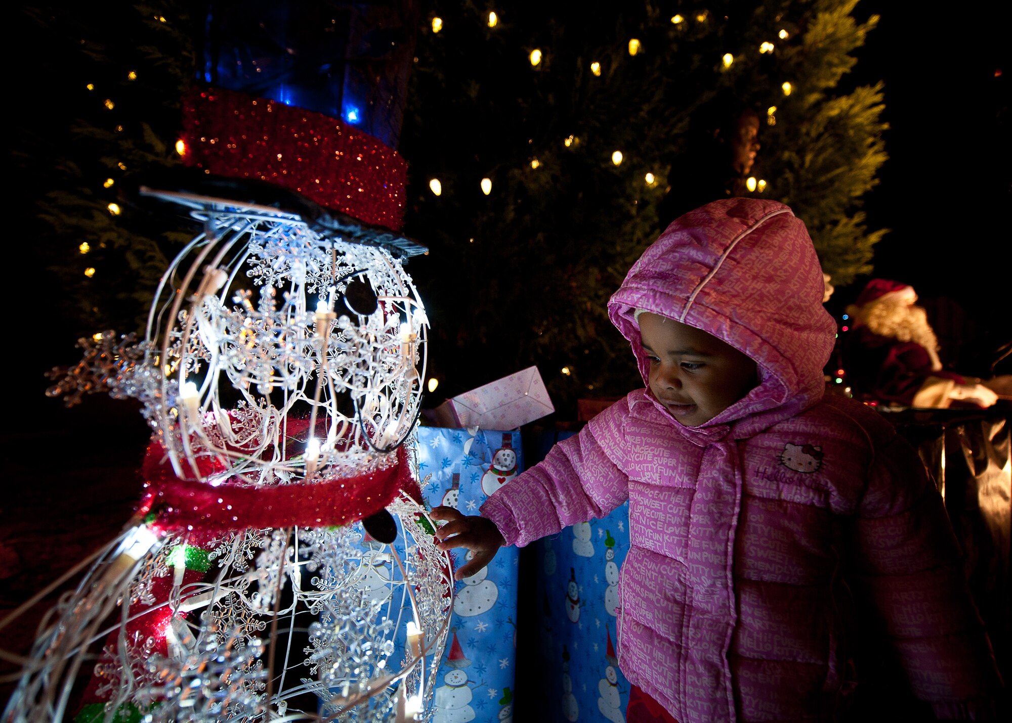Two year old Jordyn Dix is enchanted by the holiday lights at the Maxwell Air Force Base-Gunter Annex Christmas Tree Lighting ceremony on  Dec 1. The Christmas Tree Lighting was coordinated by the 42 Air Base Wing Chaplains. (Air Force photo/Donna L. Burnett)