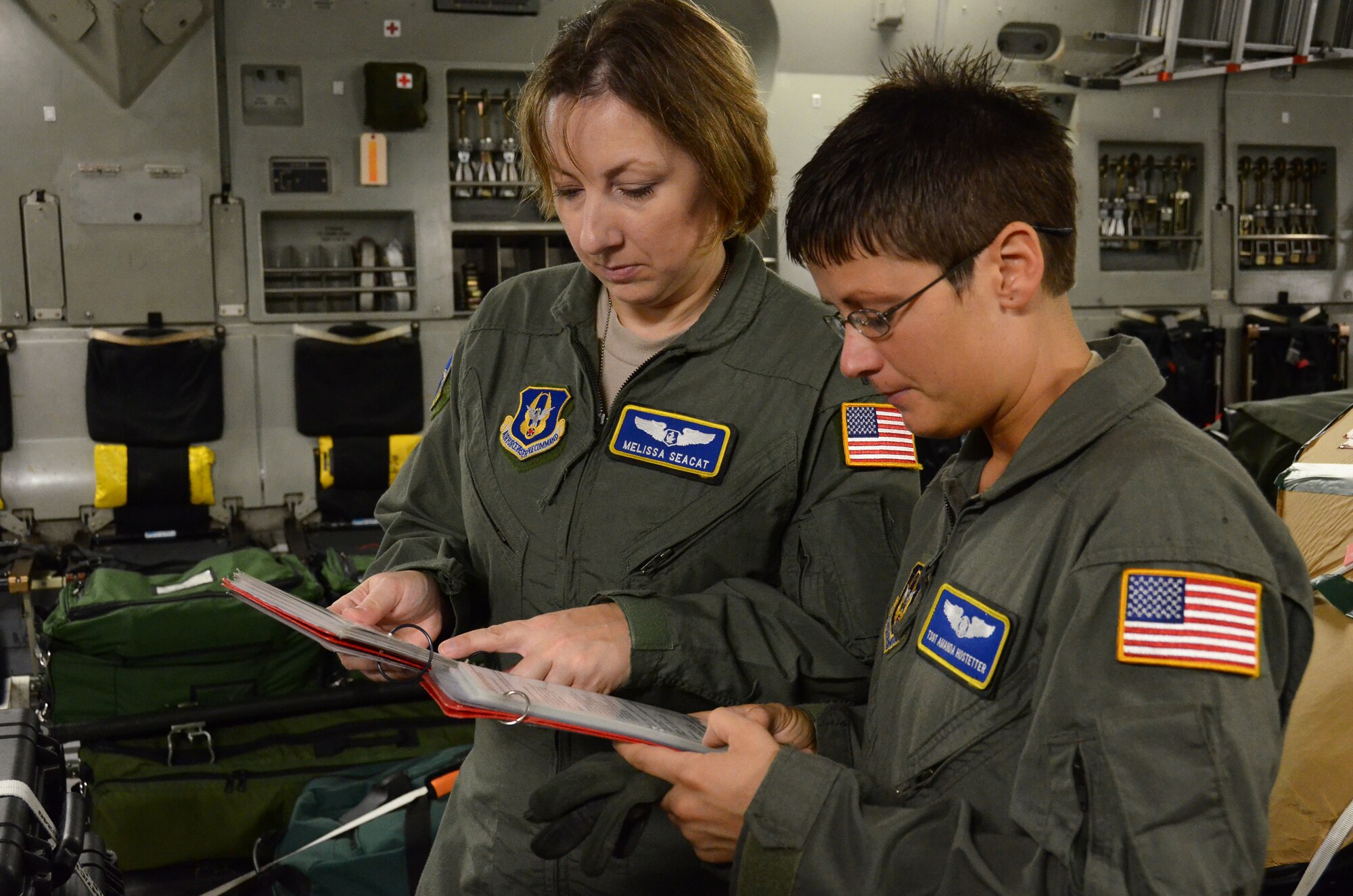 WRIGHT-PATTERSON AIR FORCE BASE, Ohio – Capt. Melissa Seacat and Tech. Sgt. Amanda Hostetter, 445th Aeromedical Evacuation Squadron, run through their checklists in preparation for their flight to participate in the South African Air Show Sept. 24. (U.S. Air Force photo/Senior Airman Mikhail Berlin)