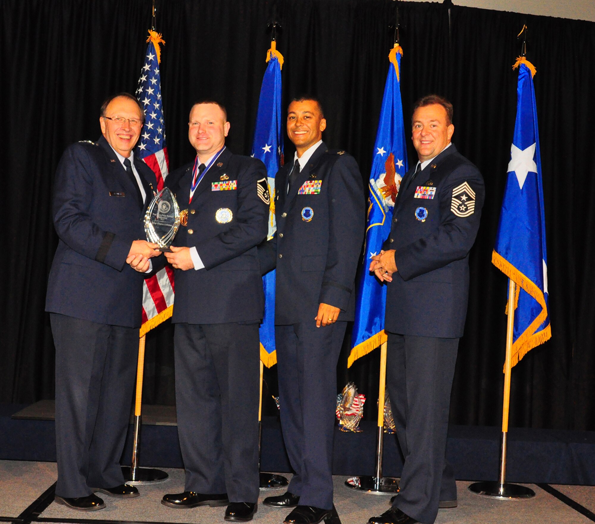 WRIGHT-PATTERSON AIR FORCE BASE, Ohio - Master Sgt. Clayton Callahan was recognized as the 2011 Gold Medalist-Top Non Prior Service Recruiter of the year Oct. 27. Lt. Gen. Charles Stenner, Jr., commander of Air Force Reserve Command and chief of the Air Force Reserve, congratulates him as Col. Joe Wilburn, AFRC Recruiting Service commander and director of recruiting and Chief Master Sgt. Robert Starkey, AFRC Recruiting Service command chief, look on. (Courtesy photo)