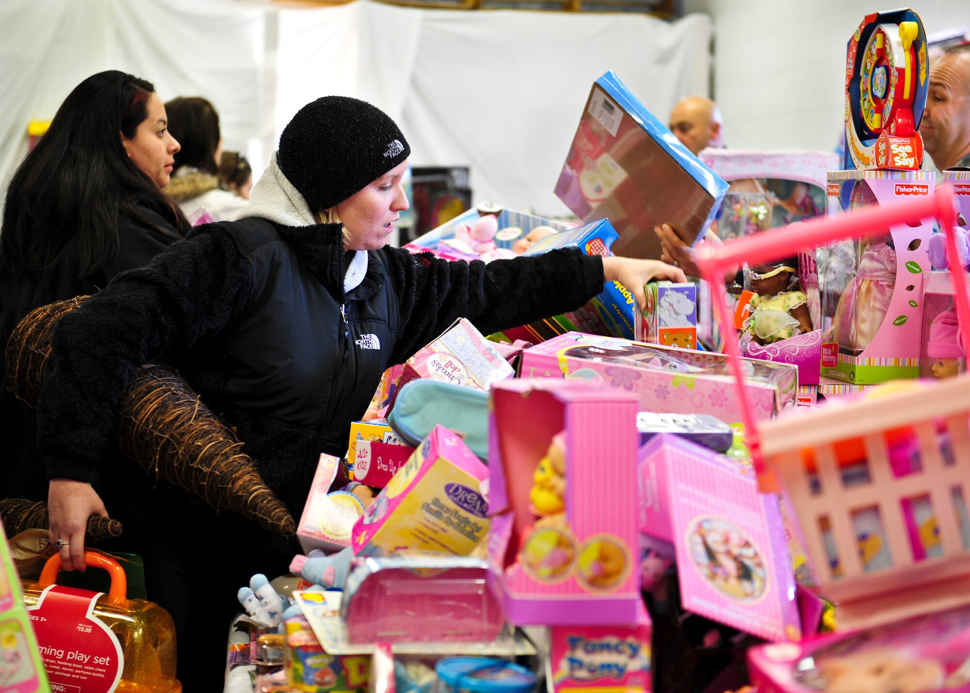 Ashley Walker searches for the perfect toy for her 2-year-old daughter at the 8th annual toy distribution Nov. 30 at the Airman’s attic. Members of all services up to the grade of E-5, lined up to find the perfect gift for their children. More than 4,000 toys were donated for the event, helping more than 200 families in the Eglin community. (U.S. Air Force photo/Sachel Seabrook)