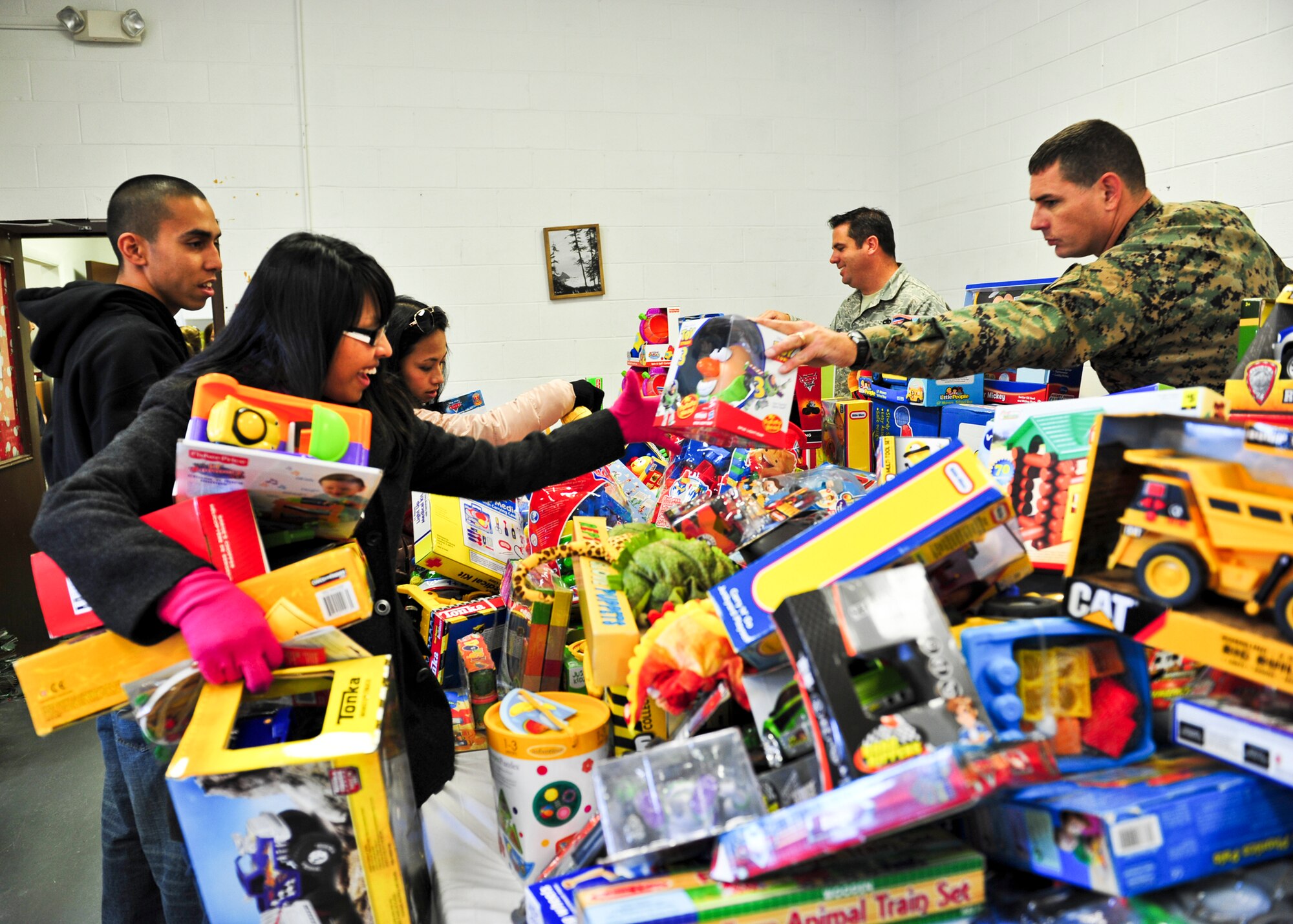 Service members were on hand to help families pick out gifts at the 8th annual toy distribution Nov. 30 at the Airman’s Attic. More than 4,000 toys were donated for the event, helping more than 200 families in the Eglin community.  (U.S. Air Force photo/Sachel Seabrook)