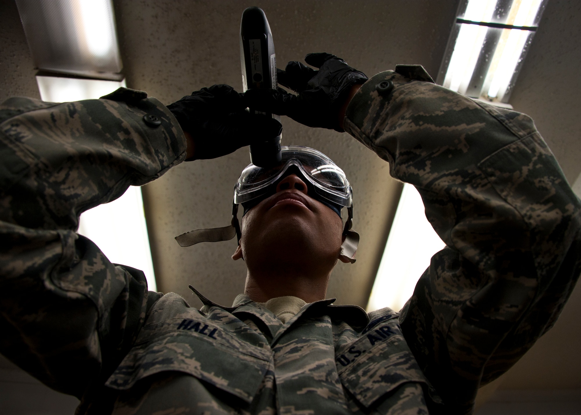 Airman 1st Class Troy Hall, with the 96th Logistics Readiness Squadron, holds up a refractometer to verify the level of the fuels system icing inhibitor additive contained in JP-8. Airmen in the Eglin fuels lab evaluate more than 200 aviation and ground fuel samples each month.  These steps are taken to ensure water, additives and sediment amounts are at or below the proper levels.  (U.S. Air Force photo/Samuel King Jr.)
