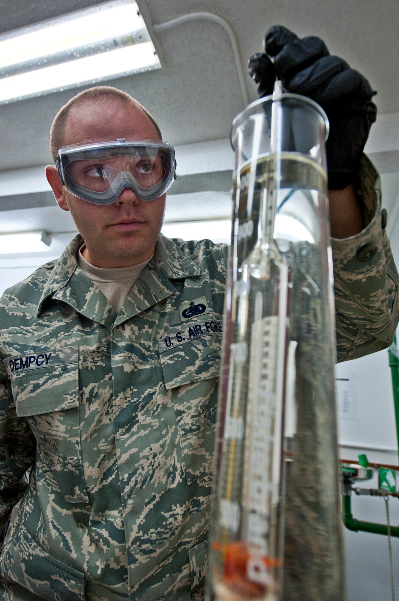 Tech. Sgt. Seth Dempcy, 96th Logistics Readiness Squadron, uses a hydrometer to measure the density of JP-8 in the fuels lab at Eglin Air Force Base, Fla.  Airmen in the Eglin fuels lab evaluate more than 200 aviation and ground fuel samples each month.  These steps are taken to ensure water, additives and sediment amounts are at or below the proper levels.  (U.S. Air Force photo/Samuel King Jr.)