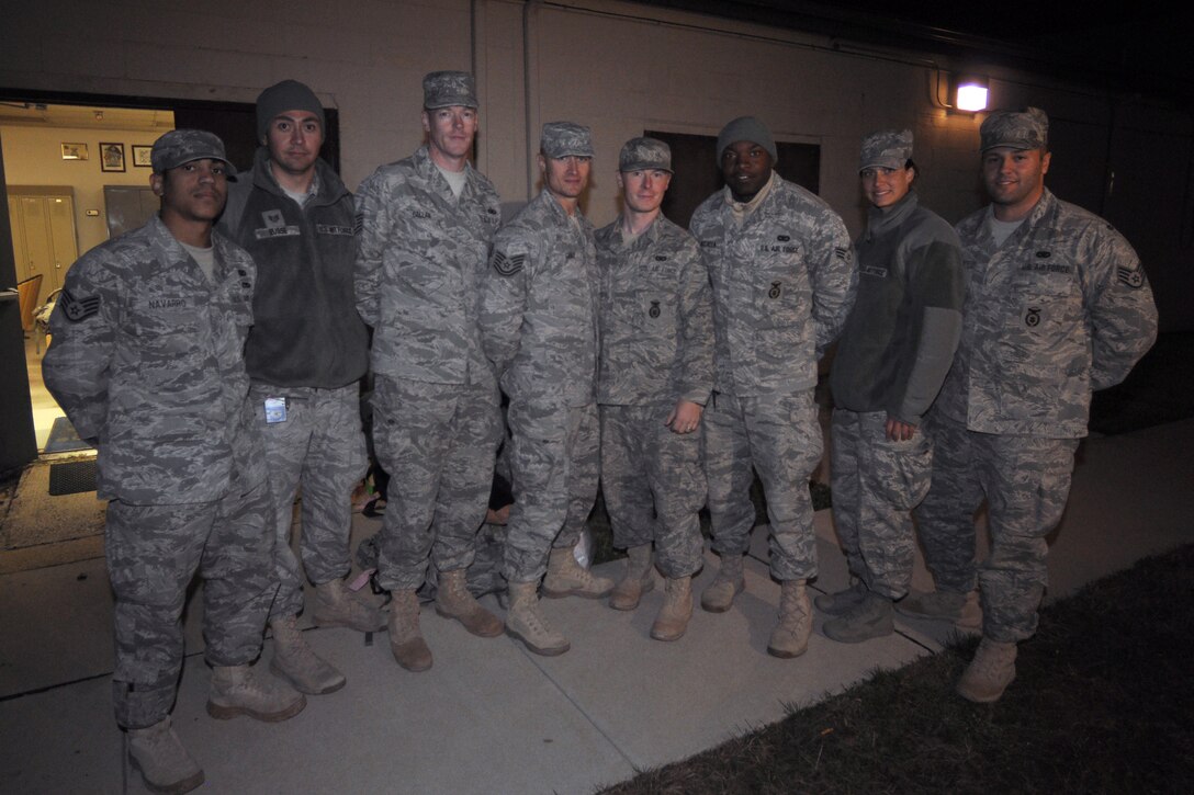 Eight New Jersey National Guard's Airmen from the 108th Security Forces Squadron returned home Dec. 2, from a recent deployment to Iraq. From left to right, Staff Sgts. Omar Navarro, Newark resident and Miguel Eusse, Linden; Tech. Sgts. Dennis Callan, Philadelphia and Chris Gable, Somers Point; Staff Sgt. Donald Bunce, Wrightstown; Senior Airmen Errol McCalla, Belle Mead and Keri Wanner, Scotch Plains; and Staff Sgt. James Cervone, Chicago, Ill., pose for a group photo at the 108th SFS building at Joint Base McGuire-Dix-Lakehurst. (U.S. Air Force photo by Staff Sgt. Armando Vasquez, 108th WG/PA)