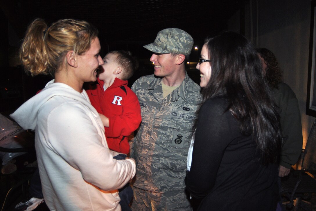 Staff Sgt. Donald Bunce, center, is all smiles as he is reunited with his sister, Ashley Laramai, and his wife, Mary, right, on Dec. 2, at Joint Base McGuire-Dix-Lakehurst, N.J., from a recent deployment to Iraq. Bunce was one of eight Airmen from the 108th Security Forces Squadron returning home from the approximately six-month deployment. (U.S. Air Force photo by Staff Sgt. Armando Vasquez, 108th WG/PA)