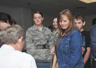 Debbie Germany waits her turn to sign out and host Air Force basic trainees Jessica Bernard and Stephanie Davidson, 344th Training Squadron, Flight 026, for Thanksgiving Nov. 24 at the Basic Military Training Reception Center. (U.S. Air Force photo/Alan Boedeker)