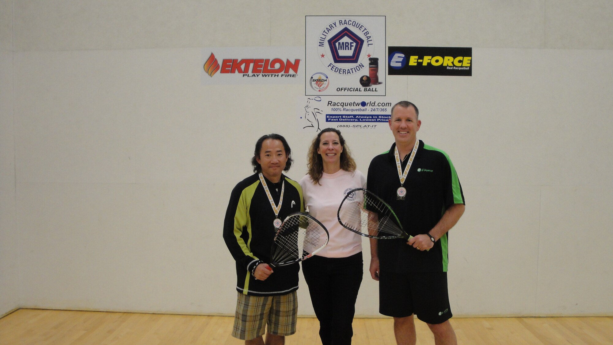 Partners retired Master Sgt.  Yee Cheng (left) and Master Sgt. Jerry Turley (right) stand with Peggine Tellez, Military Racquetball Federation Co-founder and Officer (center), following their win in the 35+ Open Doubles Division at the MRF National Tournament in San Diego, Oct. 28-30. (Courtesy photo)