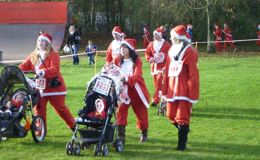 Airmen and families from RAF Croughton participate in a charity fun run/walk at Spiceball Park in Banbury Dec. 4. More than 30 Airmen and their families participated in the walk, in which every participant dressed as Father Christmas. (U.S. Air Force photo by 1st Lt. Brian Maguire)