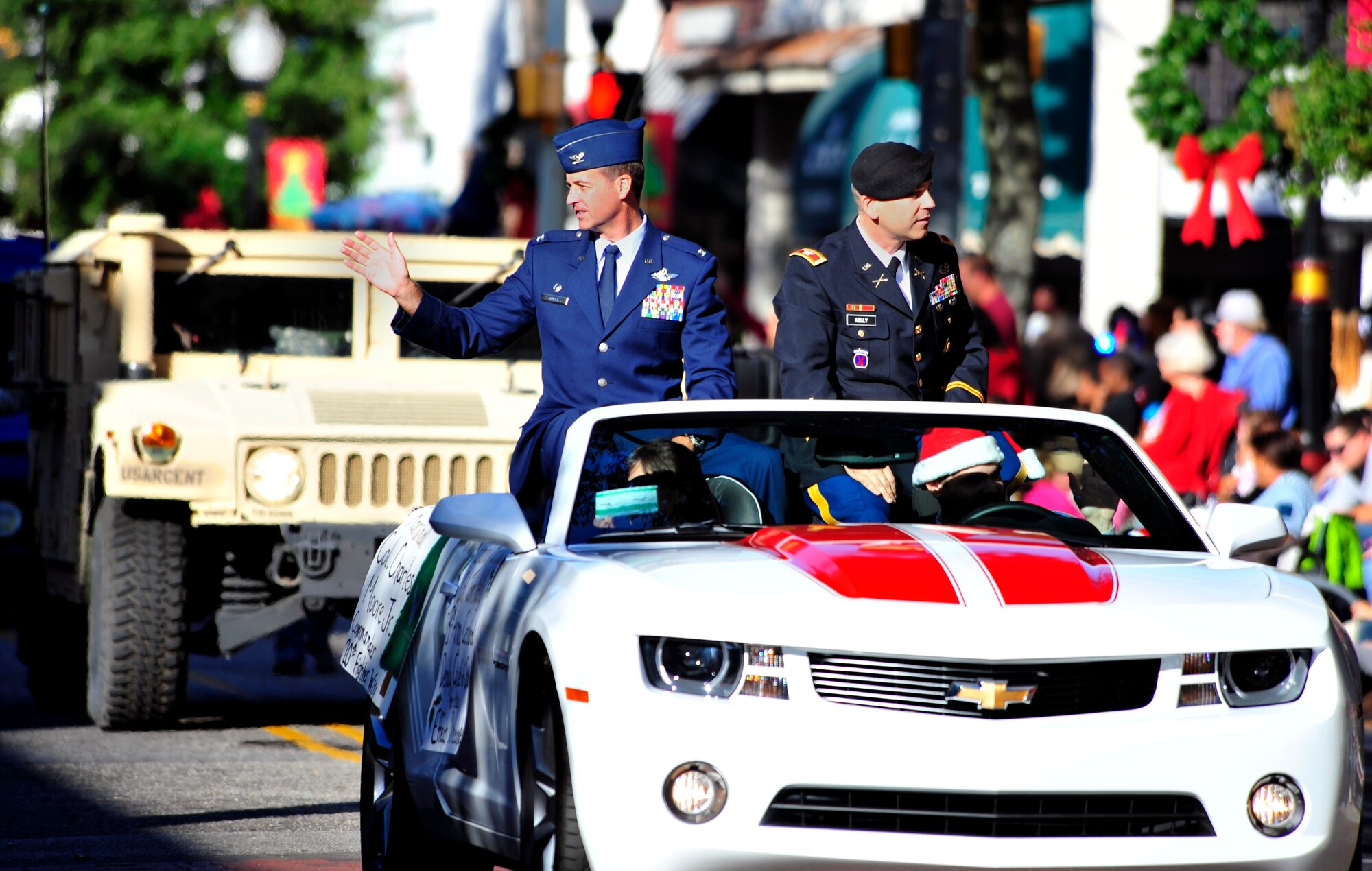 U.S. Air Force Col. Charlie Moore, 20th Fighter Wing commander, and U.S. Army Col. Tom Kelly, 3rd Army deputy chief of staff for strategy and effects, ride in a convertible during the Sumter Christmas parade down Main Street in Sumter, S.C., Dec. 4, 2011. The theme for the parade was "Christmas Memories."(U.S. Air Force photo/Senior Airman Daniel Phelps)