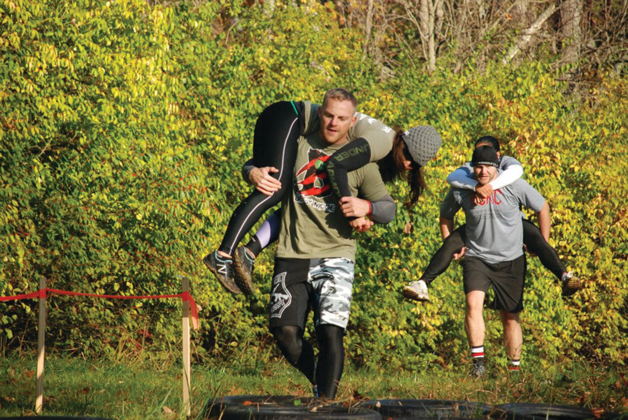 WRIGHT-PATTERSON AIR FORCE BASE, Ohio - Staff Sgt. Doug Young, Jr., 445th Airlift Wing command post, carries his partner through the woods during the Back to the Ranch CrossFit competition Oct. 22. (Courtesy photo)