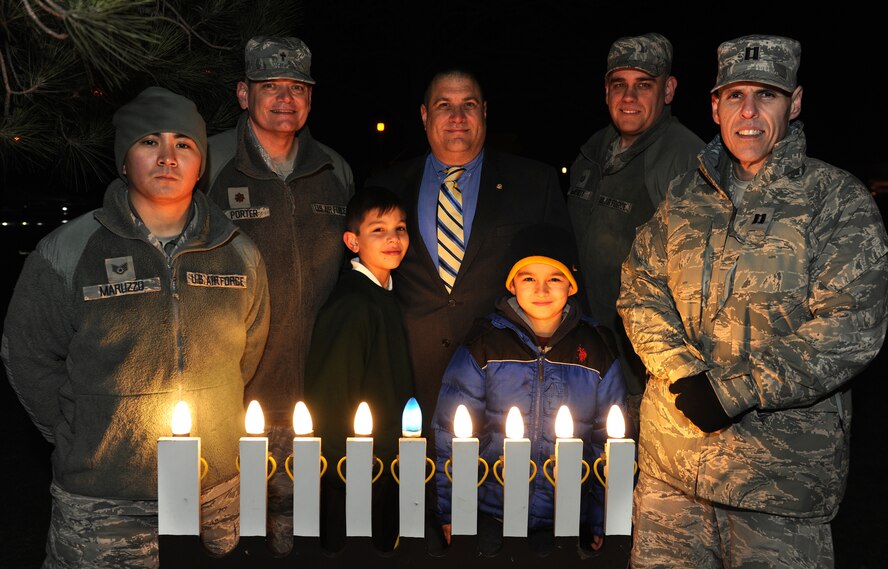RAF ALCONBURY, United Kingdom - The Alconbury Chapel staff and members of the community light the Menorah during the annual holiday lighting ceremony Dec. 2. (U.S. Air Force photo by Tech. Sgt. John Barton)