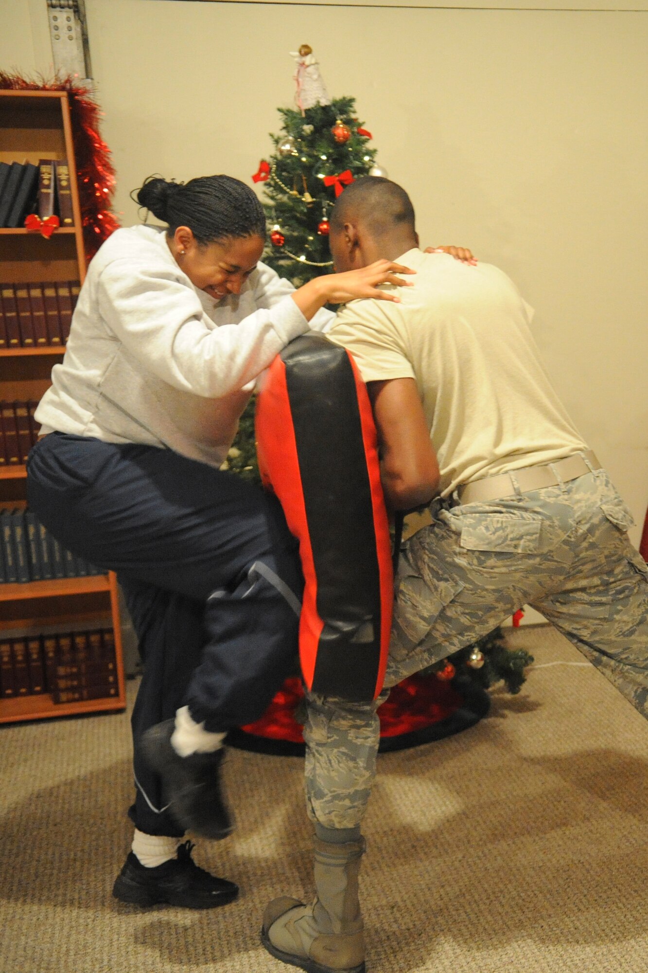 Staff Sgt. Michelle Bell practices driving her knee into a simulated predator during a self-defense class here Dec. 3, 2011. The class focused on simple defensive techniques students could use if they found themselves in a threatening situation. Bell is a 376th Expeditionary Force Support Squadron recreation specialist deployed from Little Rock Air Force Base, Ark. (U.S. Air Force photo/Tech. Sgt. Tammie Moore)
