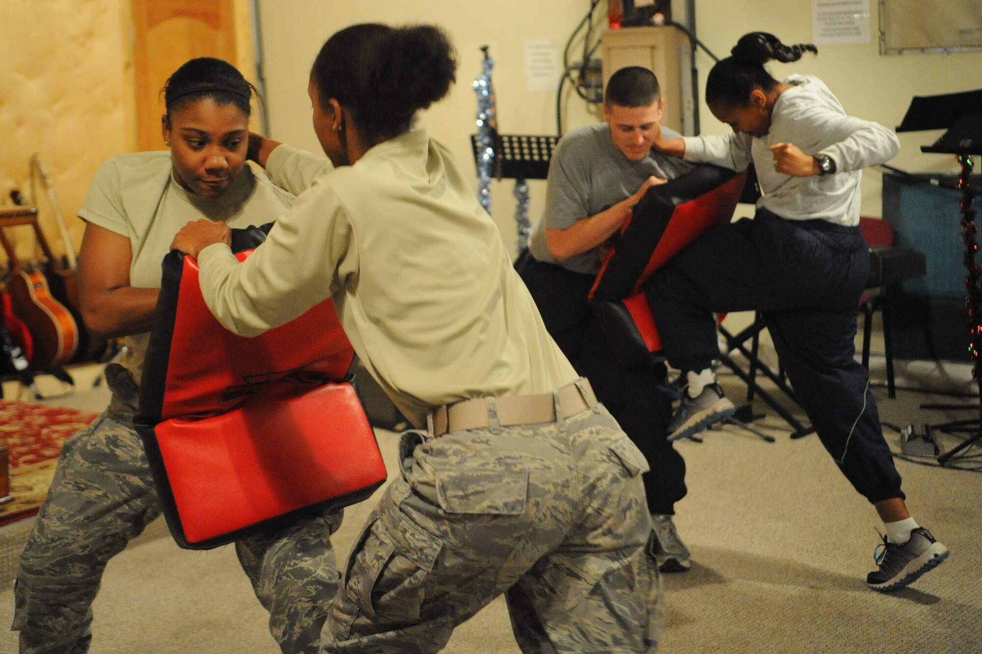 A group of students practice driving their knees into a simulated predator during a self-defense class here Dec. 3, 2011. Representatives of the Sexual Assault Prevention and Response Office hosted the class. The SAPR office is committed to an aggressive, proactive program to fight and prevent sexual assaults. (U.S. Air Force photo/Tech. Sgt. Tammie Moore)