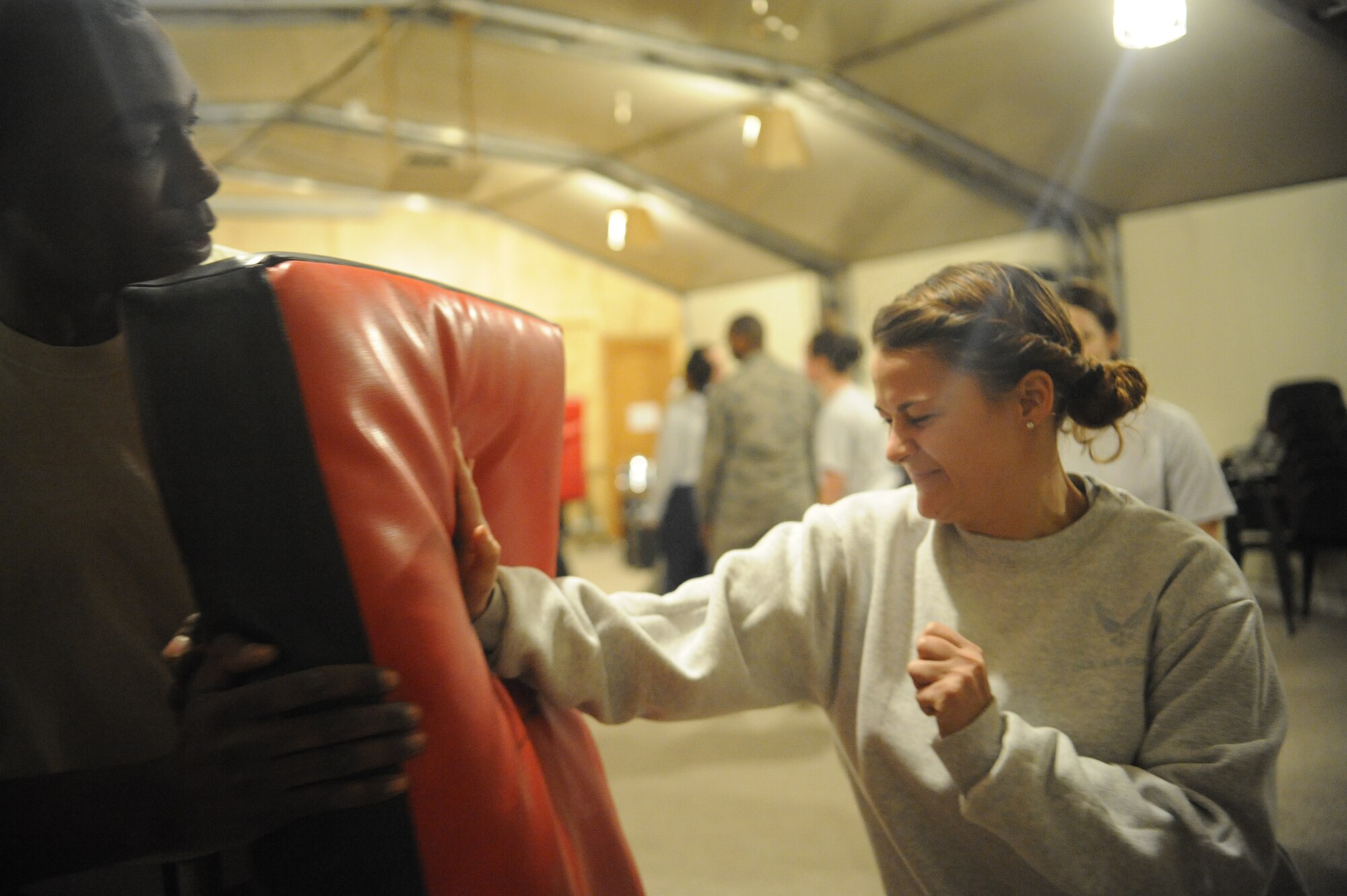 Senior Airman Corri Williams practices palm striking a potential predator during a self-defense class here Dec. 3, 2011. Representatives of the Sexual Assault Prevention and Response Office hosted the class. Williams is a 376th Expeditionary Force Support Squadron recreation specialist deployed from McConnell Air Force Base, Kan. (U.S. Air Force photo/Tech. Sgt. Tammie Moore)