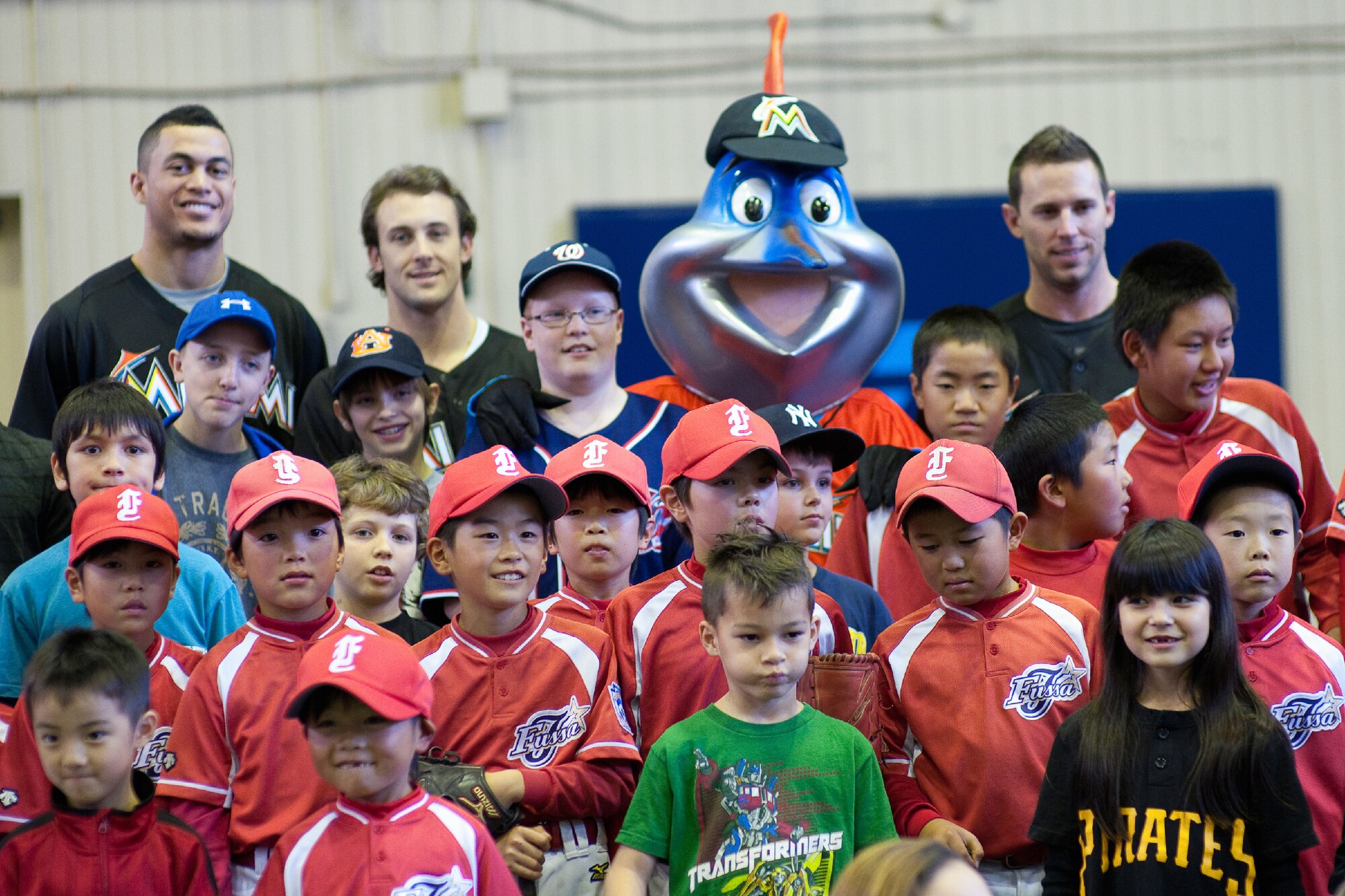 YOKOTA AIR BASE, Japan -- Participants and Major League Baseball players from the Miami Marlins pose for a group photo with Billy the Marlin after a baseball clinic held at the Yokota Teen Center, Dec. 3, 2011. The Marlins along with Billy the Marlin and Marlins Mermaids, held activities such as a baseball clinic, a dance clinic, and meet and greets, put on by the Armed Forces Entertainment.  (U.S. Air Force photo/Osakabe Yasuo)   