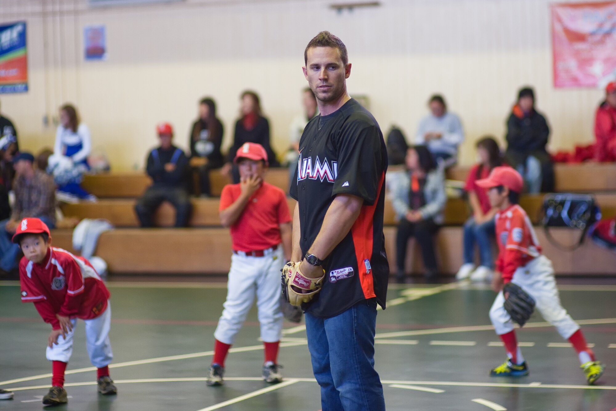 YOKOTA AIR BASE, Japan -- Brett Hayes, a Major League Baseball catcher for the Miami Marlins, plays baseball with participants during a baseball clinic held at the Yokota Teen Center, Dec. 3, 2011. The Marlins, along with Billy the Marlin and Marlins Mermaids, held activities such as a baseball clinic, a dance clinic and meet and greets, sponsored by Armed Forces Entertainment. (U.S. Air Force photo/Osakabe Yasuo)   