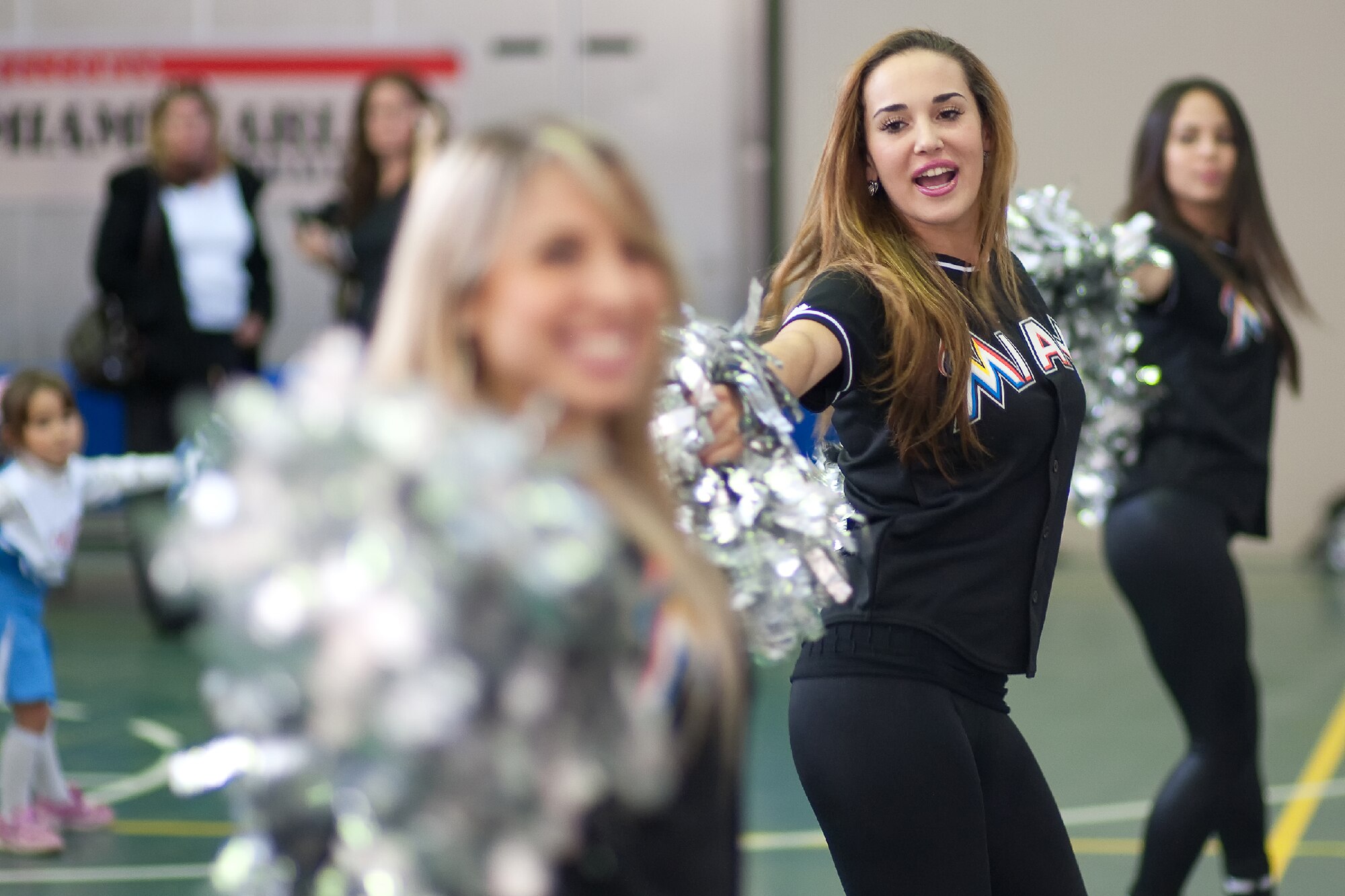 YOKOTA AIR BASE, Japan -- Ashley (center) of the Marlins Mermaids and her teammates teach cheerleading to participants during a dance clinic held at the Yokota Youth Center, Dec. 3, 2011. The Mermaids, along with Billy the Marlin and Marlins players, held activities such as a baseball clinic, a dance clinic, and meet and greets, sponsored by Armed Forces Entertainment. (U.S. Air Force photo/Osakabe Yasuo) 