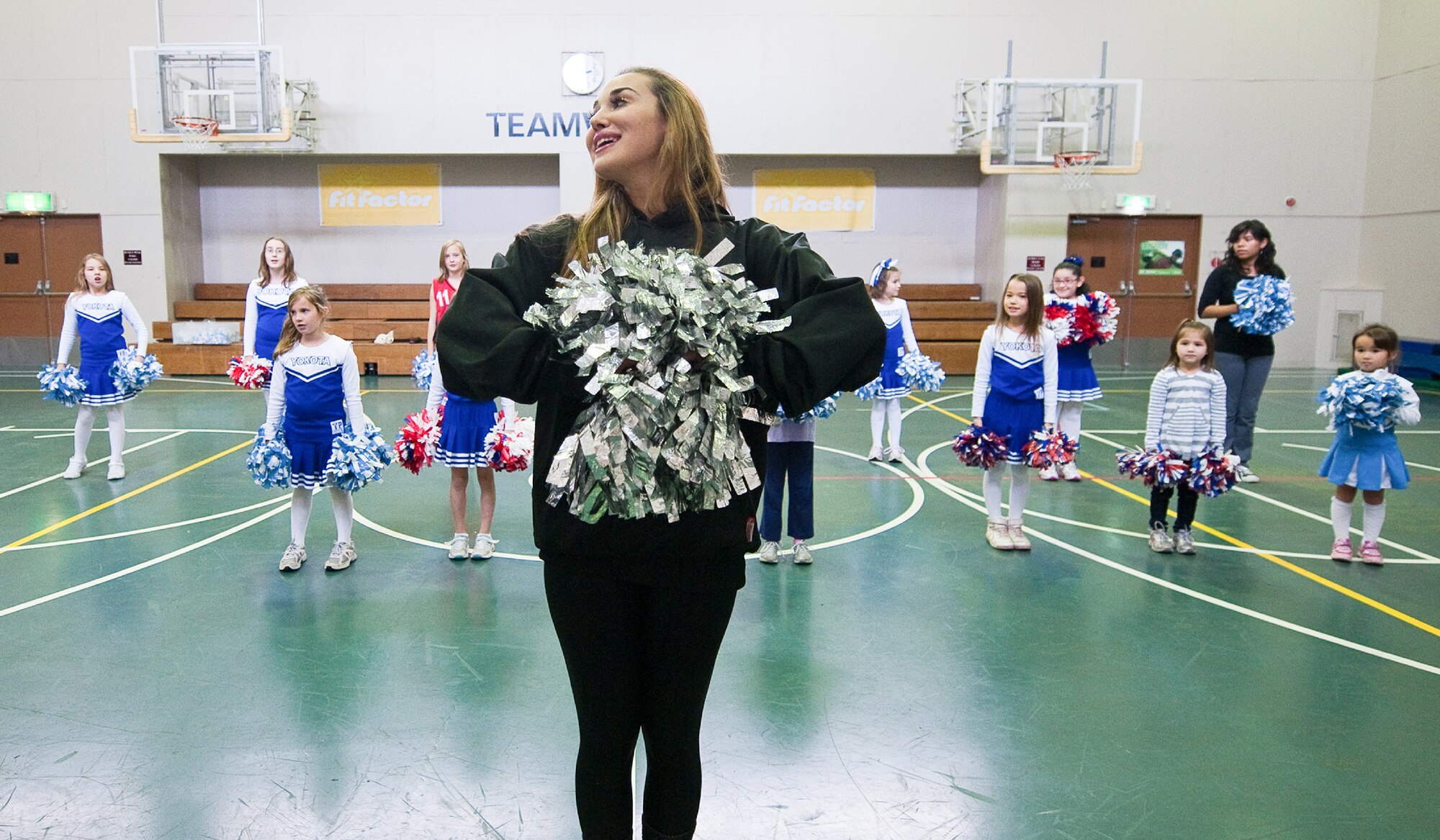 YOKOTA AIR BASE, Japan -- Ashley, of the Marlins Mermaids, teaches cheers to participants during a dance clinic held at the Yokota Youth Center, Dec. 3, 2011. The Mermaids, along with Billy the Marlin and Marlins players, held activities such as a baseball clinic, a dance clinic and meet and greets, sponsored by Armed Forces Entertainment.  (U.S. Air Force photo/Osakabe Yasuo)