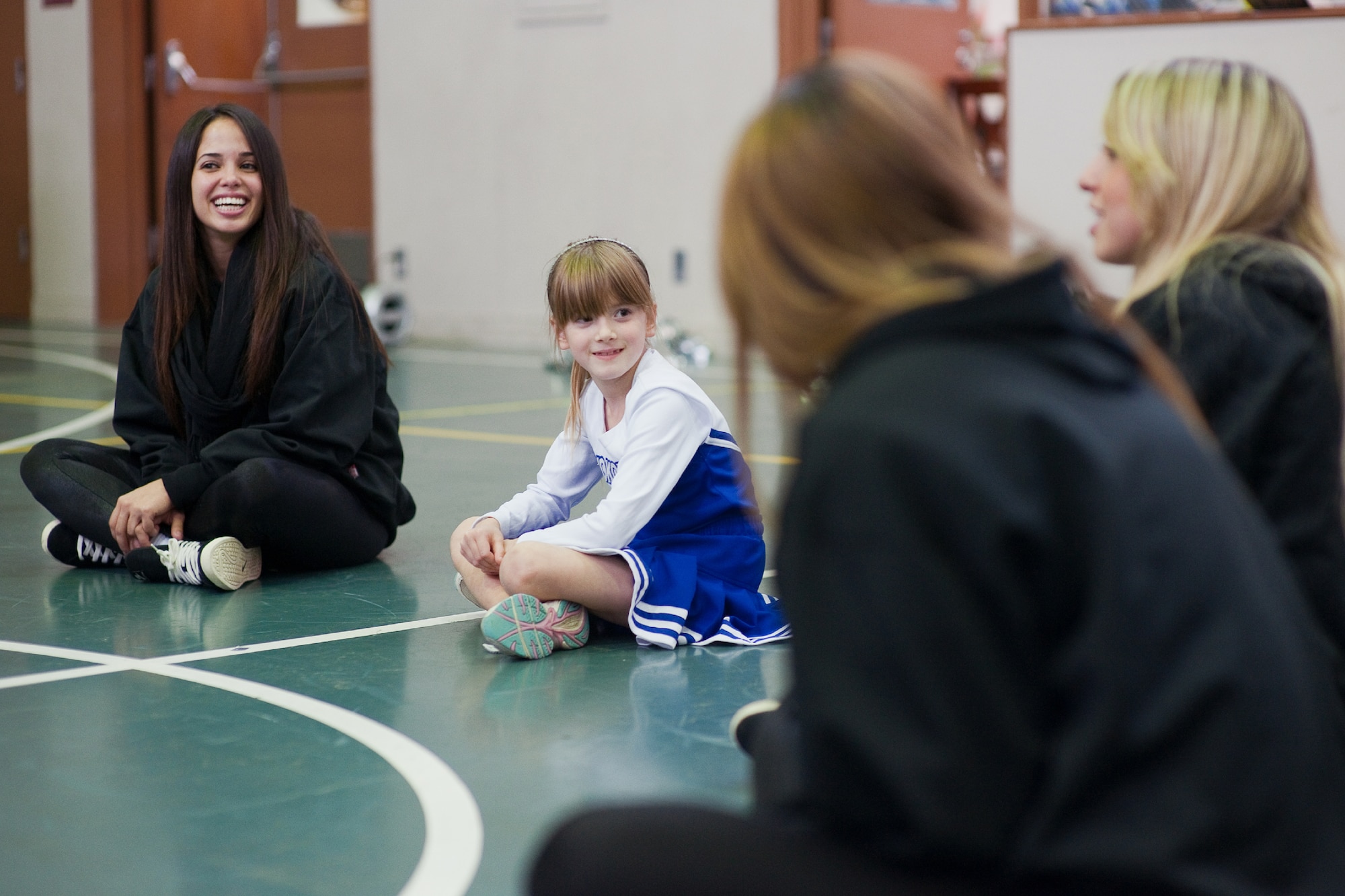 YOKOTA AIR BASE, Japan -- Aiko Galvin, a 2nd grade student at Joan K. Mendal Elementary School, introduces herself to Marlins Mermaids cheerleaders during their visit at Yokota Air Base, Japan, Dec. 3, 2011. The Mermaids along with Billy the Marlin and Marlins players, held activities such as a baseball clinic, a dance clinic and meet and greets, sponsored Armed Forces Entertainment. (U.S. Air Force photo/Osakabe Yasuo)