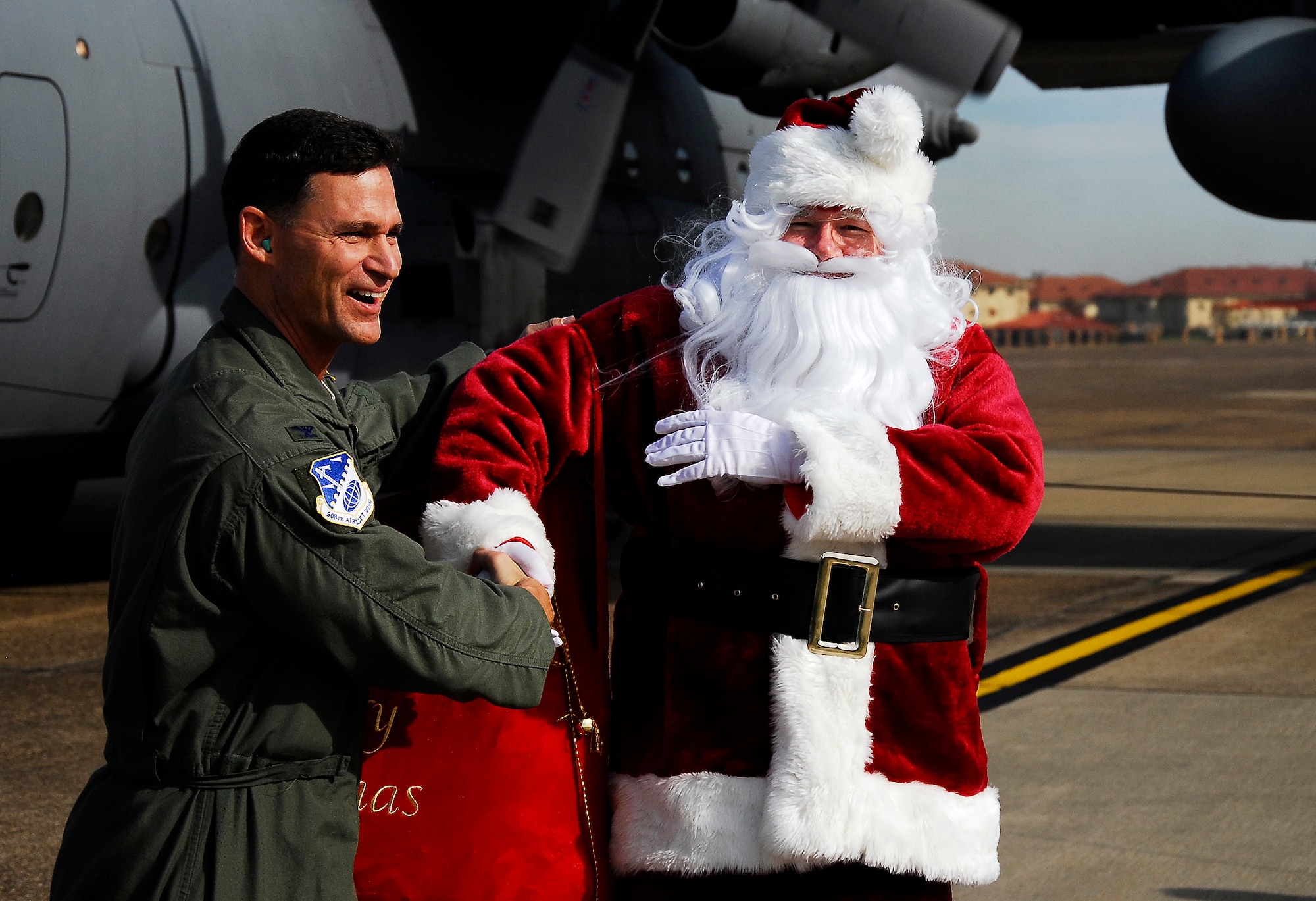 Santa Claus is welcomed to the 908th Airlift Wing by its commander, Col. Brett Clark.