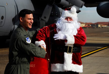 Santa Claus is welcomed to the 908th Airlift Wing by its commander, Col. Brett Clark.
