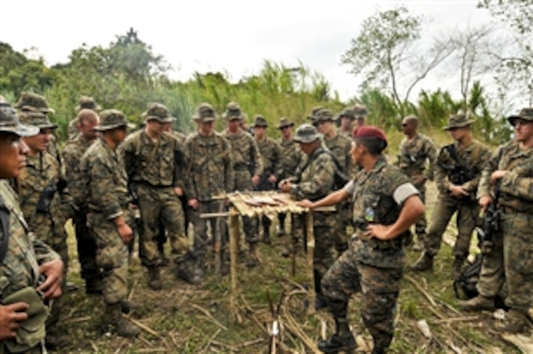 A member of the Guatemalan special forces shows methods of preparing fish to U.S. Marines in Peutro Barrios, Guatemala, Nov. 28, 2011. The Marines, assigned to Special Purpose Marine Air Ground Task Force, attended a subject-matter exchange to see how Guatemalan special forces survive in the jungle without packaged food. The Marines are supporting Amphibious-Southern Partnership Station 2012, an annual deployment of U.S naval assets in the U.S. Southern Command area of responsibility.