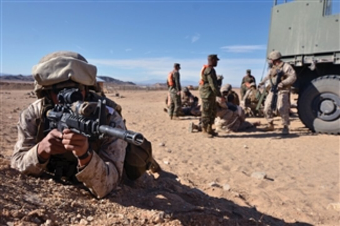 Lance Cpl. John A. Degmore provides security during an improvised explosive device response drill on Nov. 24, 2011.  The drill included simulated wounds, explosives and smoke.   Degmore is a military policeman with Combat Logistics Battalion 4, Combat Logistics Regiment 3, 3rd Marine Logistics Group, III Marine Expeditionary Force.  