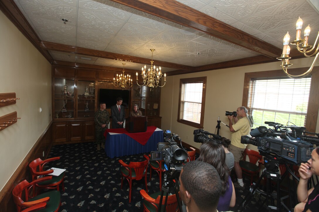 Roy Cooper, North Carolina attorney general, and Holly Petraeus, the assistant director for the Office of Service Member Affairs, Consumer Financial Protection Bureau, speak to the media during a press conference at the Paradise Point Officers' Club aboard Marine Corps Base Camp Lejeune, Dec. 6, to hear from Marines and sailors about scams they've encountered. Since the Dodds-Frank financial bill passed this year, the CFPB Office of Service Members Affairs was created to protect service members and their families from fraudulent business activity::r::::n::::r::::n::::r::::n::