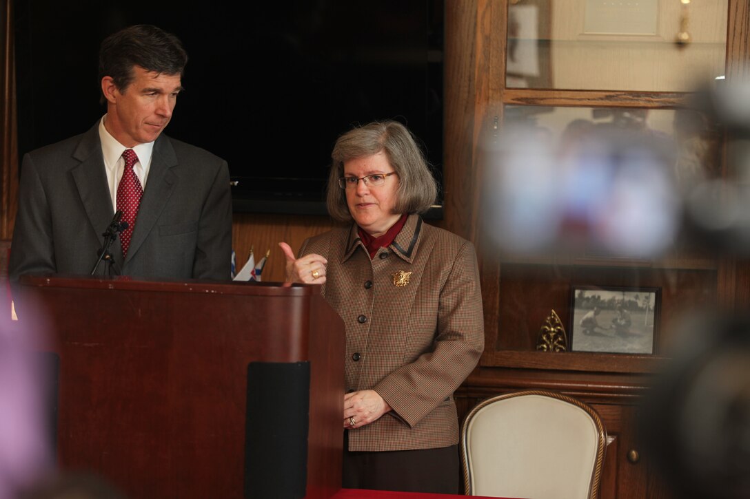 Roy Cooper, North Carolina attorney general, and Holly Petraeus, the assistant director for the Office of Service Member Affairs, Consumer Financial Protection Bureau, speak to the media during a press conference at the Paradise Point Officers' Club aboard Marine Corps Base Camp Lejeune, Dec. 6, to hear from Marines and sailors about scams they've encountered. Since the Dodds-Frank financial bill passed this year, the CFPB Office of Service Members Affairs was created to protect service members and their families from fraudulent business activity::r::::n::::r::::n::::r::::n::