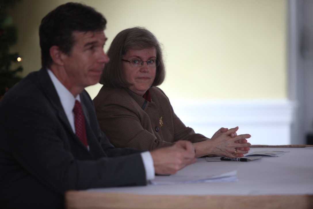 Roy Cooper, North Carolina attorney general, and Holly Petraeus, the assistant director for the Office of Service Member Affairs, Consumer Financial Protection Bureau, speak to service members at the Paradise Point Officers' Club aboard Marine Corps Base Camp Lejeune, Dec. 6, to hear from Marines and sailors about scams they've encountered. Since the Dodds-Frank financial bill passed this year, the CFPB Office of Service Member Affairs was created to protect service members and their families from fraudulent business activity.::r::::n::::r::::n::::r::::n::