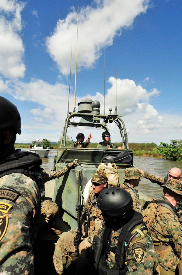 Boatswain's Mate Seaman Patrick Cunningham, a U.S. Navy Riverine from Riverine Squadron (RIVRON 3) Detachment 1 (Det. 1), points out the next location where U.S. Marines attached to Special Purpose Air Ground Task Force (SPMAGTF) and members of the Guatemalan Naval Special Forces will conduct their next subject matter expert exchange (SMEE) in Santo Tomas Dec. 6.  The simulation was held with U.S. Marines attached to a Special Purpose Marine Air Ground Task Force (SPMAGTF) and members of the Guatemalan Naval Special Forces. The Riverines and SPMAGTF Marines are participating in the SMEE exchanges as a part of Amphibious-Southern Partnership Station 2012 (AMPHIB-SPS 12), an annual deployment of U.S. military teams to the U.S. Southern Command area of responsibility.