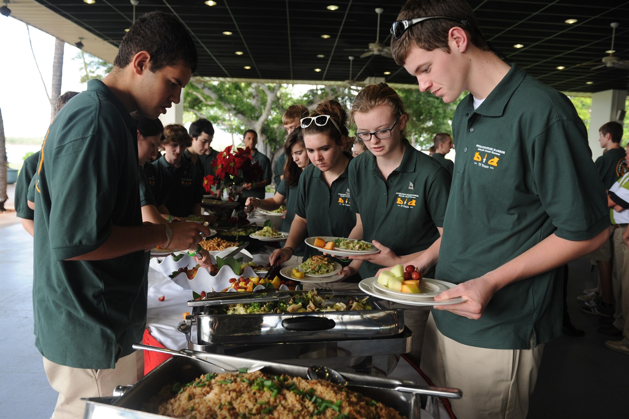 Students of the Central High School Marching Band, Manchester, New Hampshire, eat lunch at the Hickam Officer's Club following their performance at Atterbury Circle, Joint Base Pearl Harbor-Hickam, Hawaii, on Dec. 6, 2011. The band paid a visit to Oahu to honor three fallen school alumni who were killed in action during the Dec. 7, 1941 attacks. (U.S. Air Force photo/Staff Sgt. Mike Meares) 