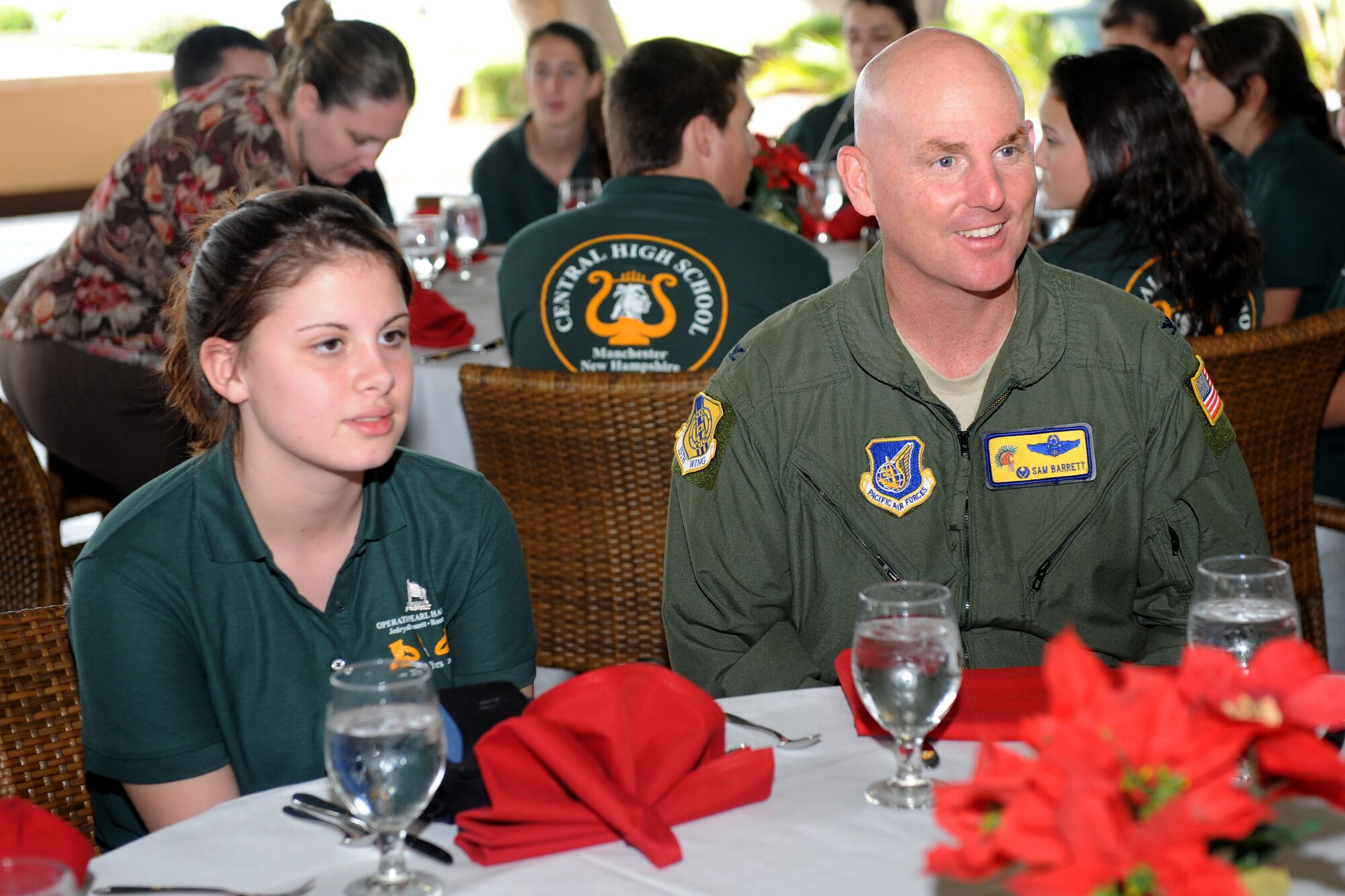 Col. Sam Barrett, 15th Wing commander, eats lunch at the Hickam Officer's Club with students from Central High School Marching Band, Manchester, New Hampshire, during their visit to Joint Base Pearl Harbor-Hickam, Hawaii, Dec. 6. The high school band performed at Atterbury Circle to pay tribute to three fallen CHS alumni earlier in the day. (U.S. Air Force photo/Staff Sgt. Mike Meares)