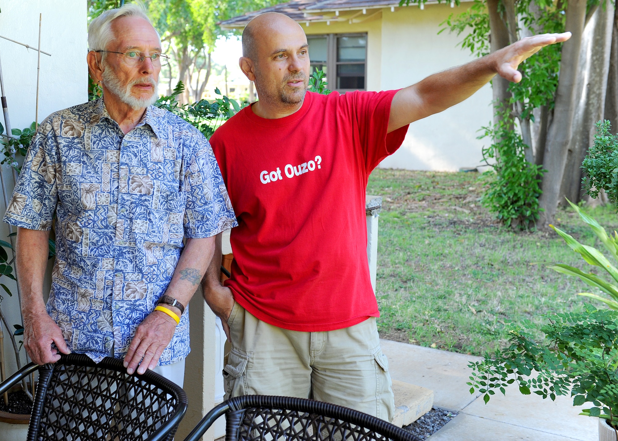 Master Sgt. Dimitros Xadzipulos, a communications planner for 13th Air Force, shows Hickam Field survivor Larry Bush how things have changed in the neighborhood in the last 70 years.  Larry Bush’s father was an Airman stationed at Hickam Field, and he was only 8- and at home Dec. 7. 1941 and survived the sudden attacks by the Japanese. Her and her brother Larry Bush visited the base where 70 years ago they survived, ahead of the 70th Anniversary commemoration of the attacks on U.S. military forces stationed at Oahu. (U.S. Air Force photo/Tech. Sgt. Jerome S. Tayborn/Released)
