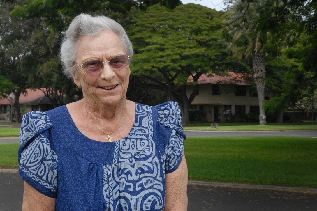 Bea Sullivan, 89, stands in front of her former residence on Joint Base Pearl Harbor-Hickam, Hawaii, Dec. 5. Her husband, U.S. Air Force 2nd Lt. Robert Sullivan, was a B-18 pilot stationed at Hickam Field in 1941. He was on a temporary duty assignment in Sacramento, Calif., on Dec. 7, 1941, when the Japanese attacked the base. Bea, then 19, recalled hiding under the bed. (U.S. Air Force photo by Staff Sgt. Carolyn Herrick)
