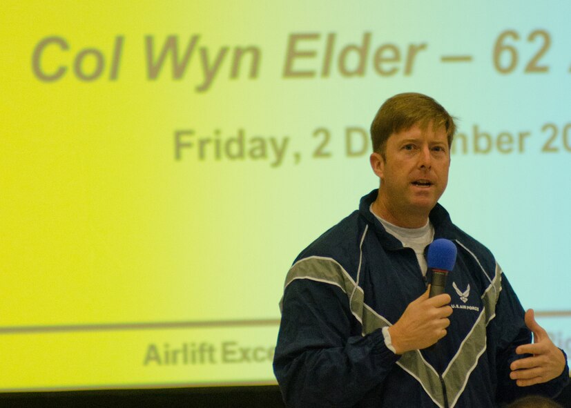 Col. Wyn Elder, 62nd Airlift Wing commander, speaks during Wingman Day on Dec. 2, 2011, in Hangar 4 at Joint Base Lewis-McChord, Wash. "Wingman Day is not a thing," he said. "It's everyone one of us, so we owe it to one another to take care of one another." (U.S. Air Force photo/David Poe)